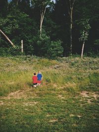 Full length of man standing on tree trunk