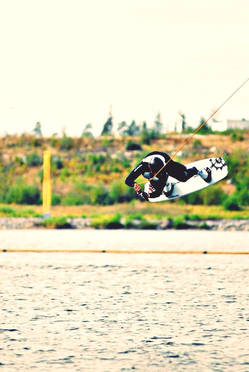 clear sky, focus on foreground, selective focus, sport, copy space, day, outdoors, leisure activity, riding, sunlight, balance, men, shoe, surface level, sky, close-up, hobbies, human representation