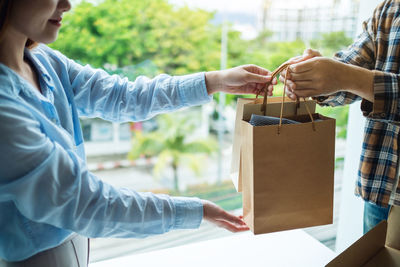 Cropped hand of woman holding gift box