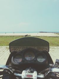 Close-up of vintage car on field against clear sky