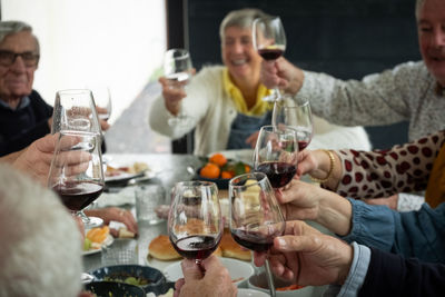 Friends toasting drinks on table