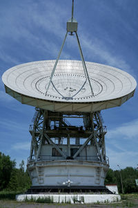 Low angle view of communications tower against sky