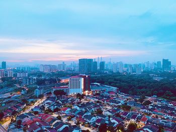 High angle view of modern buildings in city against sky