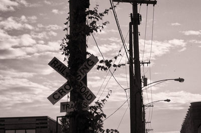Low angle view of road sign against sky