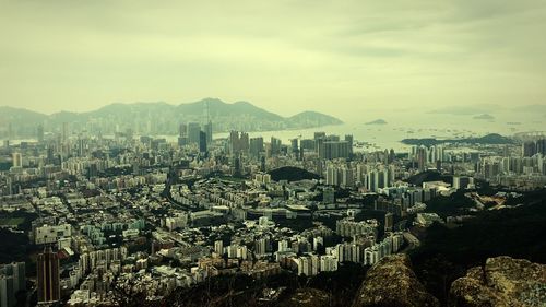 Cityscape against cloudy sky