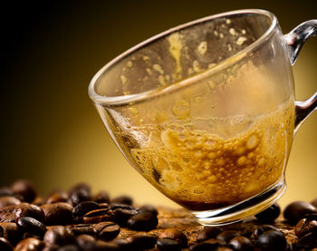 Close-up of coffee beans in glass on table