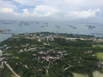 High angle view of buildings by sea against sky