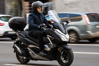 Man riding motorcycle on street