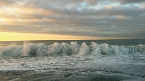 Scenic view of sea against cloudy sky