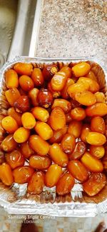 High angle view of orange fruit in container