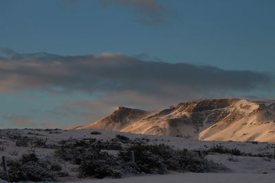 Scenic view of snowcapped mountains against sky