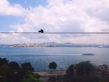 Scenic view of sea against cloudy sky