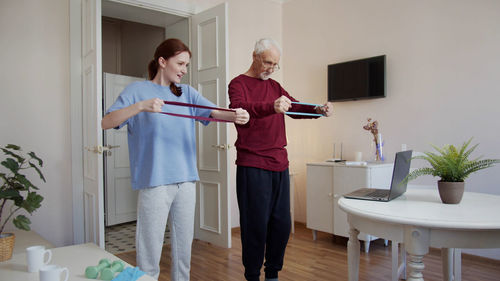 Side view of woman exercising at home