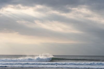 Scenic view of wave in sea against sky