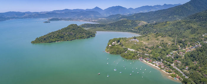 High angle view of sea and mountains against sky