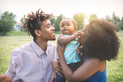 Parents playing with daughter at park