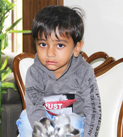 Portrait of boy sitting on chair