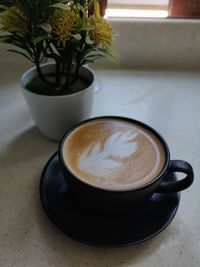 Close-up of coffee cup on table