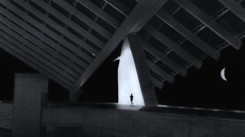 People walking on bridge at night