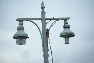 Low angle view of street light against sky