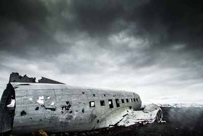Crashed plane in basaltic desert of iceland dramatic sky