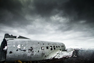 Crashed plane in basaltic desert of iceland dramatic sky