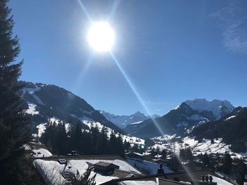 Scenic view of mountains against sky on sunny day