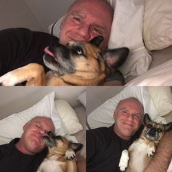 Portrait of man with dog at home