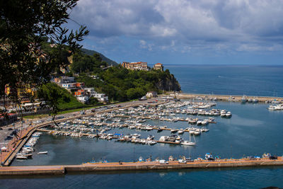 High angle view of harbor by sea against sky