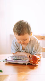 Close-up of boy playing with toy on table