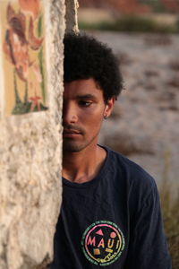 Portrait of young man standing outdoors