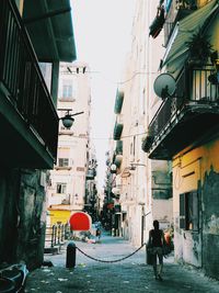 Rear view of people walking on street