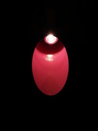 Close-up of illuminated candle against black background