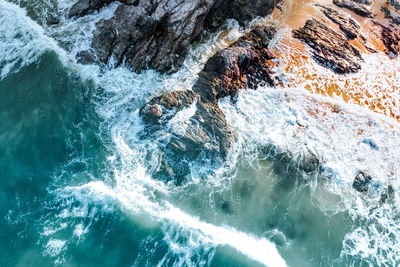 High angle view of water flowing through rocks