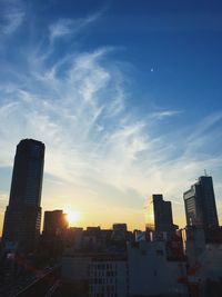 Low angle view of buildings against cloudy sky