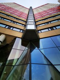 Low angle view of modern glass building against sky