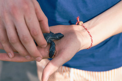 Close-up of woman holding hands