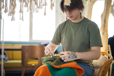 Portrait of young woman sitting at home