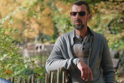 Portrait of man wearing sunglasses standing outdoors