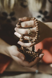 Close up on woman hands holding prayer beads