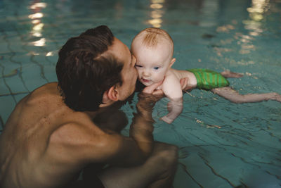 Father with baby in swimming-pool