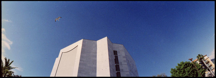 Low angle view of building against clear blue sky