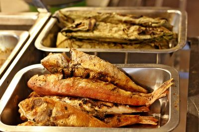 Grilled fish in containers