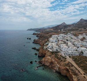 Aerial view of sea and buildings against sky