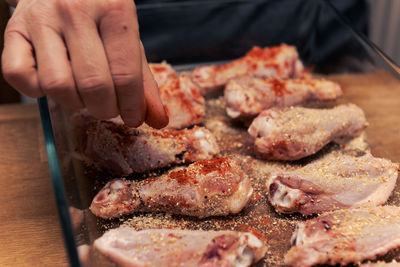 Close-up of person preparing food on table