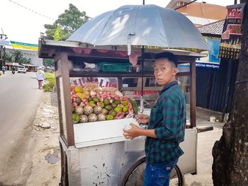 Full length of man standing at market stall