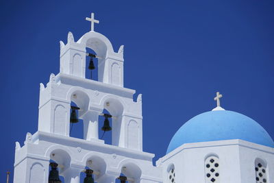 Low angle view of white building against blue sky