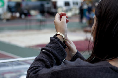 Close-up of woman wearing bracelet outdoors