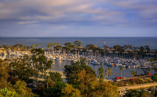 High angle view of townscape by sea against sky