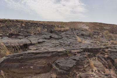 Rock formations on landscape against sky